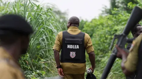 Reuters Anti drug officers inspect a site allegedly used as a clandestine methamphetamine laboratory - Ogun state, Nigeria - 22 July 2026.