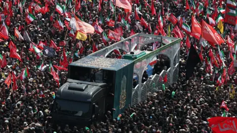 EPA Iranians take part in the funeral procession for the late Iranian Supreme Leader Ayatollah Ali Khamenei in Tehran, Iran (6 July 2026)