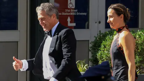 Reuters US actor Hugh Grant and his wife Anna Elisabet Eberstein wear formalwear as they walk up to the entrance of Madison Square Garden.