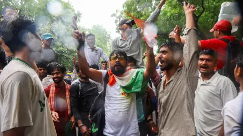 Reuters Supporters of India's Cockroach Janta Party (CJP) shout slogans, two days after thousands of protesters marched towards parliament demanding the resignation of Education Minister Dharmendra Pradhan over examination paper leaks, at Jantar Mantar in New Delhi, India, July 22, 2026.