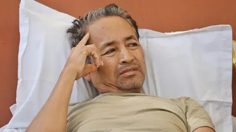 Getty Images Activist Sonam Wangchuk continues his indefinite hunger strike for the nineteenth consecutive day in solidarity with the Cockroach Janta Party (CJP), demanding the immediate resignation of Union Education Minister Dharmendra Pradhan following unprecedented paper leak irregularities during the national NEET-UG 2026 medical entrance examinations, at Jantar Mantar, on July 16, 2026 in New Delhi, India. 