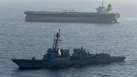 Handout photo by US. Navy via Getty Images A US military ship is seen in the foreground in the Arabian Sea in April, while another ship is seen in the background.