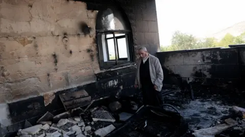 Reuters A Palestinian man inspects the damage at a mosque, which Palestinians say was damaged by Israeli settlers, in Qusra near Nablus, in the Israeli-occupied West Bank, July 26, 2026.