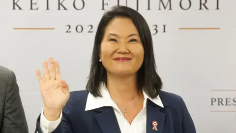 Getty Images Peru's president-elect Keiko Fujimori waves as she gives a statement at her campaign headquarters in the San Borja district of Lima on Friday.