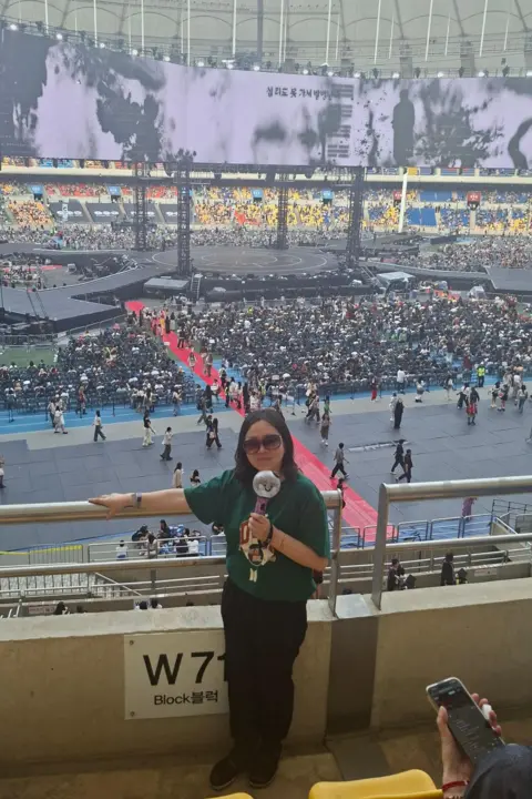 Lee Yeon-su Yeon-su holds an Army Bomb, the official BTS light stick, during the group's World Tour concert in Busan.