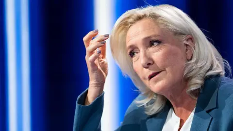 AFP via Getty Images President of Rassemblement National parliamentary group Marine Le Pen poses poses ahead of a television interview entitled "Le Grand Entretien" broadcast on French news channel LCI, in Boulogne-Billancourt, southern of Paris on July 1, 2026