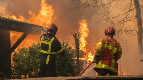 EPA A firefighting crew deployed to battle a wildfire spreading in Lege-Cap-Ferret, south western France, late 24 July 2026.