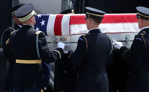 Getty Images US soldiers carry a casket during a dignified transfer ceremony in Delaware in July