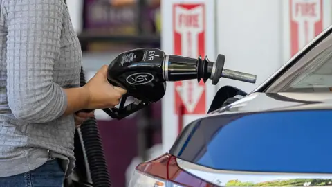 Bloomberg via Getty Images A driver refuels a vehicle at a Shell petrol station in Palo Alto, California, US
