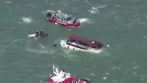 AFP Aerial images of a sinking boat in San Francisco Bay surrounded by emergency response vessels. 