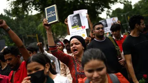 Getty Images Activists and supporters of the Cockroach Janta Party (CJP) take part in a protest demanding the resignation of India's Education Minister Dharmendra Pradhan over alleged NEET examination irregularities in New Delhi on July 20, 2026