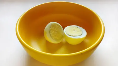 Getty Images A boiled egg placed in a yellow plastic bowl 