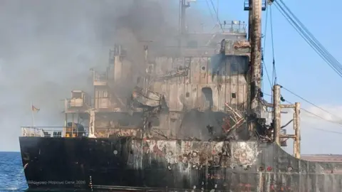 Andrii Sybiha A burning merchant ship