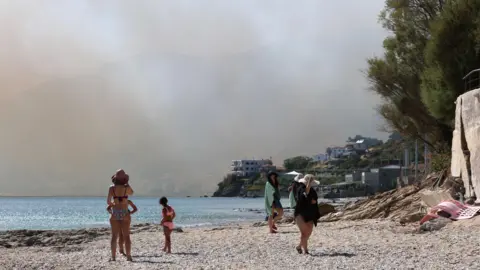 EPA/Shutterstock Smoke fills the sky as a fire burns through mixed agricultural and forest land in Plomari, Lesvos, Greece, 29 July 2026