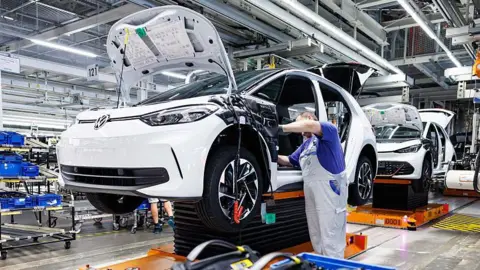 Getty Images Man working on a VW production line