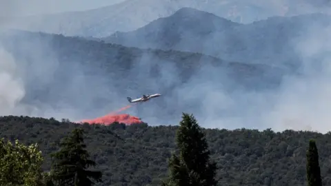 Reuters A firefighting plane drops fire retardant as it flies over a wildfire in Ille-sur-Tet near Perpignan in southern France.