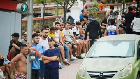 Reuters Migrants gather in downtown Ceuta, Spain, July 31, 2026, as migrants cross into Ceuta by sea and land.