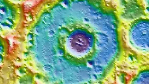 NASA The Einstein crater, seen in a colourful image, with a smaller crater within