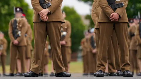 Getty Images Junior soldiers wearing full military clothing stand to attention at the Army Foundation College for their graduation parade on 2024.