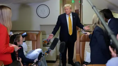 Reuters Trump speaks to reporters on the flight from the UK to the US