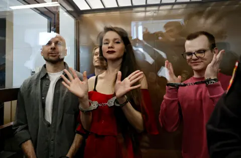 Reuters Antonina Favorskaya, Konstantin Gabov, Sergey Karelin and Artyom Kriger  are handcuffed and standing in the dock during their trial. File photo