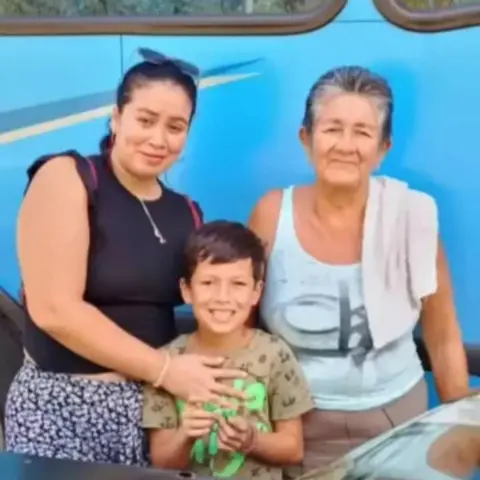 Delfín family Family photo of a mother embracing a boy beside his grandmother