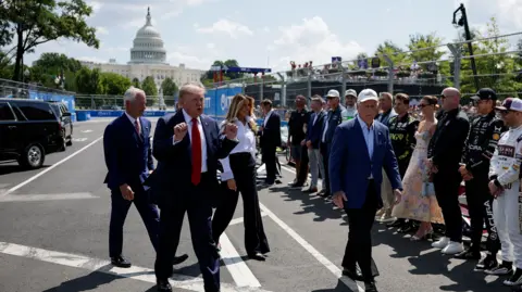 Reuters Donald Trump holds up his fists as he arrives at the event