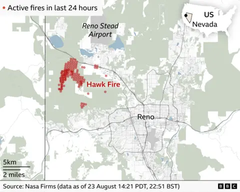 Map showing active fire detections linked to the Hawk Fire west of Reno, Nevada, over the previous 24 hours. Red dots marking fire activity are concentrated near Reno Stead Airport, with the city of Reno to the south-east.