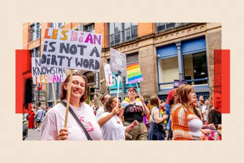 Getty Images A photo of a woman holding a placard at Manchester Pride, saying "lesbian is not a dirty word"