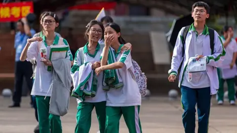 Getty Images Students walk out of the examination venue for the 2026 China's National College Entrance Exam on June 7, 2026 in Qionghai, Hainan Province of China. 