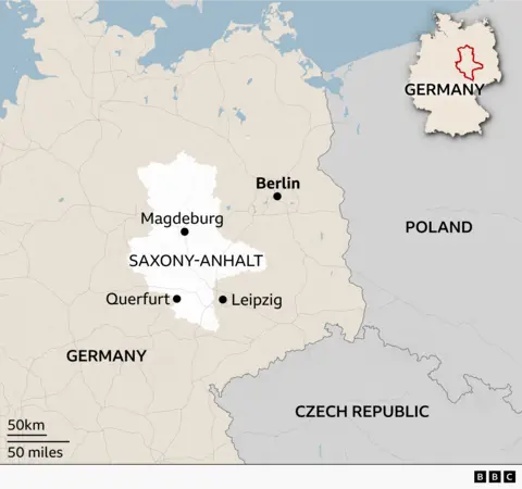Map of eastern Germany highlighting the state of Saxony-Anhalt in white. Key locations marked include Magdeburg (the state capital), Querfurt and Leipzig within or near the highlighted area, and Berlin to the northeast. Poland is shown to the east and the Czech Republic to the south. An inset map in the top right shows the location of Saxony-Anhalt within Germany. A scale bar indicates 50 km and 50 miles. BBC logo in the bottom right corner.