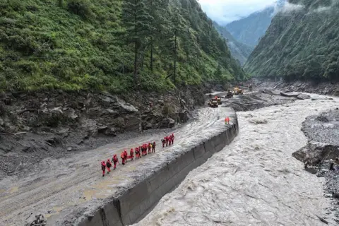 Gongga Laisong/China News Service/VCG via Getty Images Rescue workers operating in Shigatse in Tibet after devastating flooding and landslides