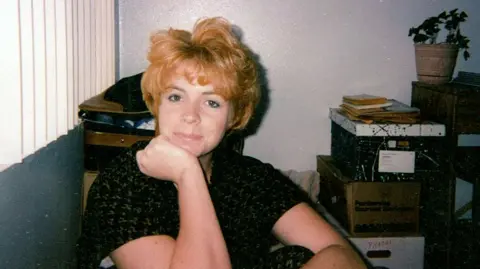 Holly Ratchford Holly Ratchford poses for a photo in an office in the late 1990s.
