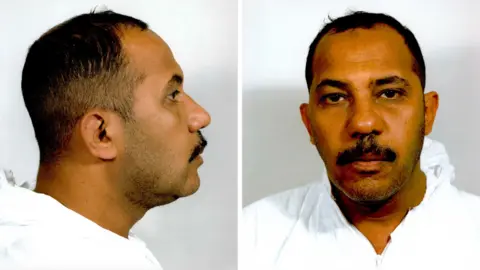 Mugshots of Omar al-Bayoumi show him in white overalls.
