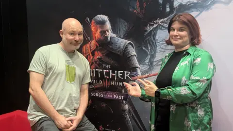 Doug Cockle, who plays Geralt, out of his Witcher uniform, alongside Laura Cress