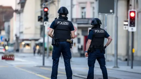 EPA Police officers patroll a street in downtown Aarau