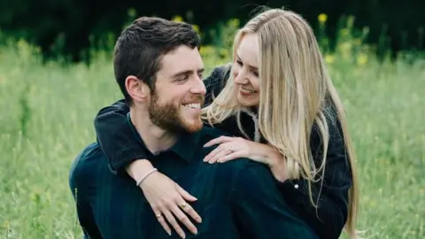 Martis Media Andrew Harper and his fiance in a field, looking at each other and smiling