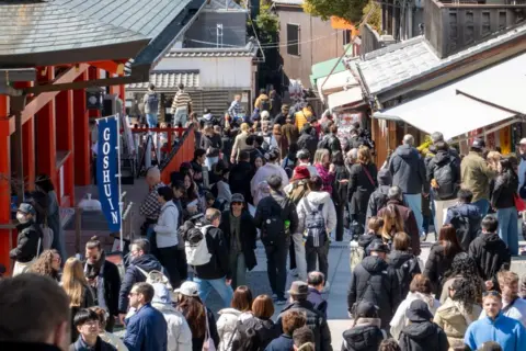 Shawn Goldberg/SOPA Images/LightRocket via Getty Images Huge crowds of tourists fill a street in Kyoto