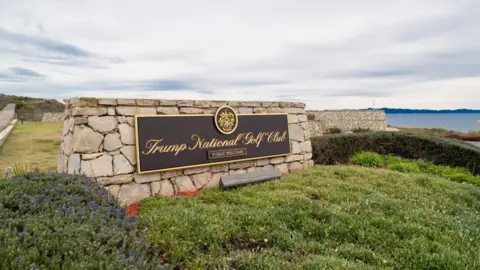 Getty Images A sign for Trump's golf course overlooks a bluff in California