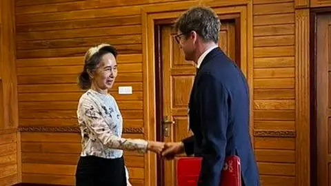 Myanmar Military Information Committee Former Myanmar president Aung San Suu Kyi shakes hands with an official from the International Committee of the Red Cross