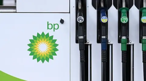 Bloomberg / Getty Images Close up of petrol and diesel pumps with the BP logo to the side