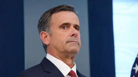 Getty Images John Ratcliffe seen in a navy suit, with a red tie.