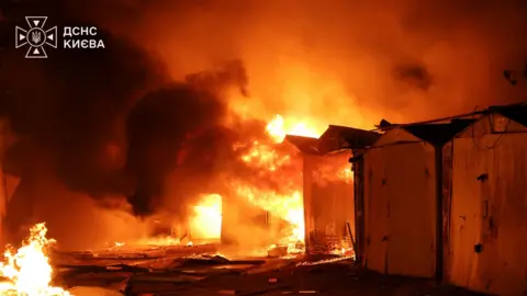 Ukraine state emergency service DSNS Garages ablaze in Ukraine.