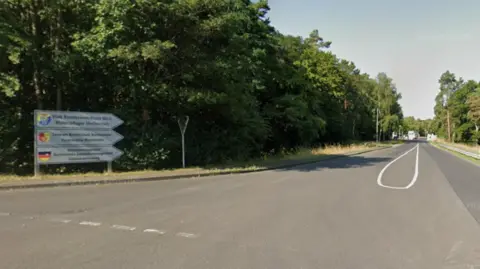 Google A sign leading to Mechernich military base, with the entry checkpoint visible in the distance.