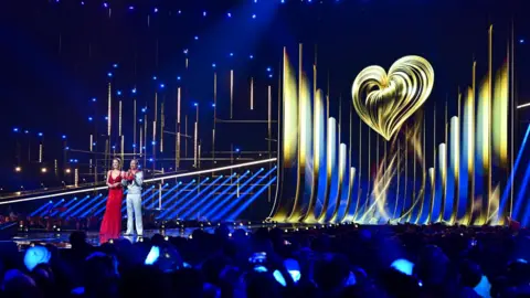 Getty Images The Eurovision stage at the Vienna contest earlier this year, the two hosts are at the front with the Eurovision logo as the backdrop