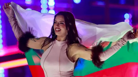 Hannibal Hanschke/EPA/Shutterstock Eurovision winner Dara waving a Bulgarian flag