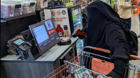 DOJ/FBI The woman in a black niqab with a shopping trolley seen buying bomb-making parts at a local hardware store