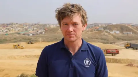 World Food Programme/PA A man with brown hair looking at the camera, he is wearing a navy polo top