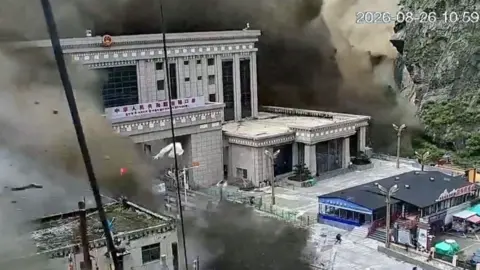 Reuters CCTV shows people running as mud and water destroys buildings in Gyirong, Tibet