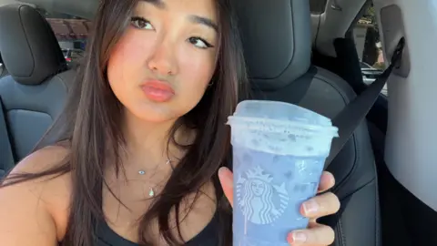 Elaine Ling Elaine Ling holds a lavender Grande Ocean Drink from Starbucks